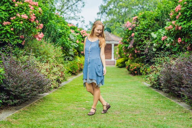 Young woman enjoying a beautiful blooming garden