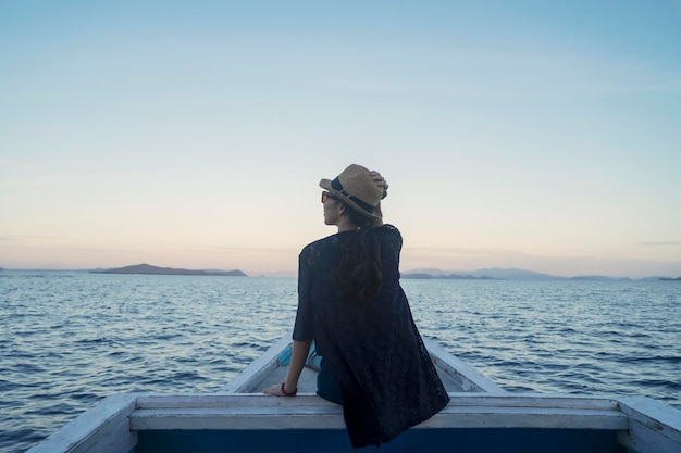 Young woman enjoying beautiful seascape on the boat