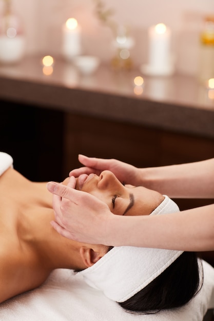 Young woman enjoying face massage