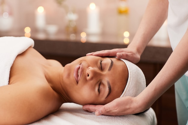 Young woman enjoying face massage