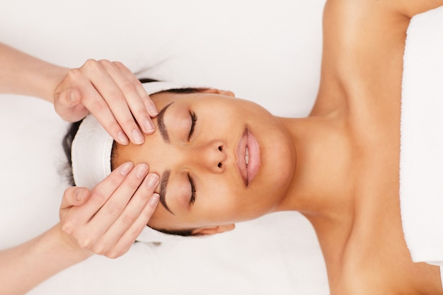 Young woman enjoying face massage