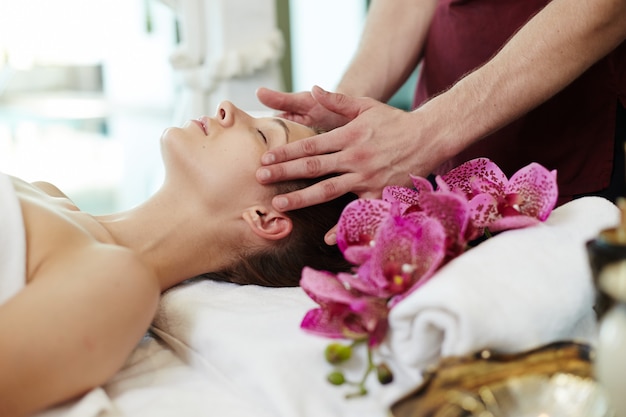 Young Woman Enjoying Facial SPA