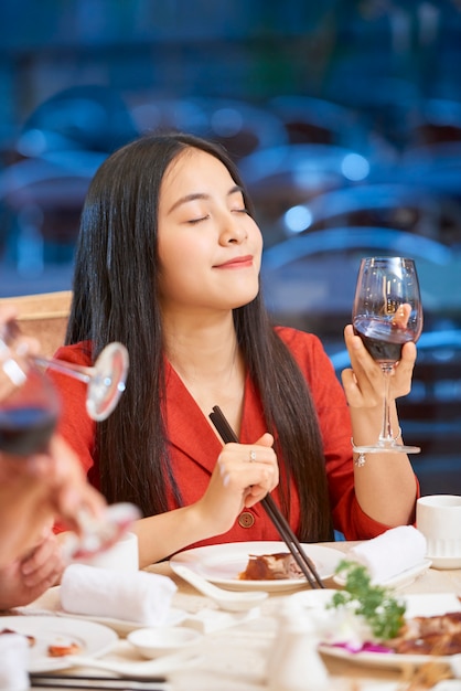 Young woman enjoying good wine