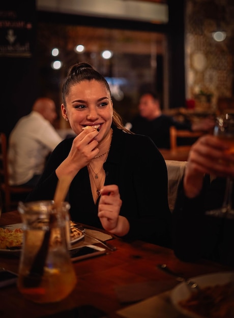 A young woman enjoying herself in a restaurant