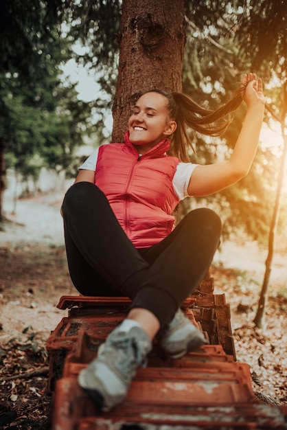 Young woman enjoying nature picnicking in nature walking in the forest enjoying the sunset