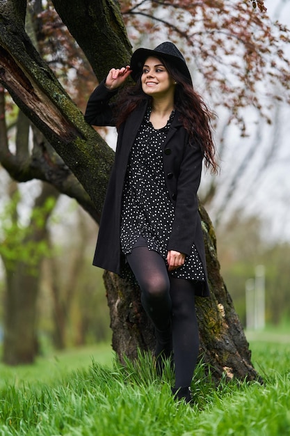 Young woman enjoying a spring rainy day in the park