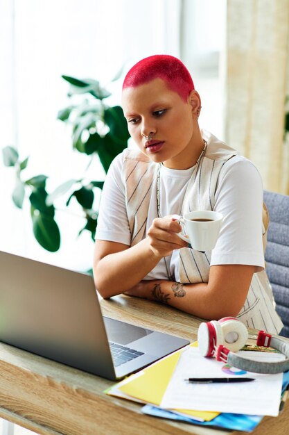 A young woman enjoys coffee while working at her stylish home office during a productive day