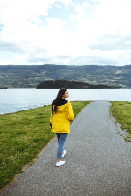 Young woman enjoys freedom against the backdrop of the mountains in the Norway The girl tourist