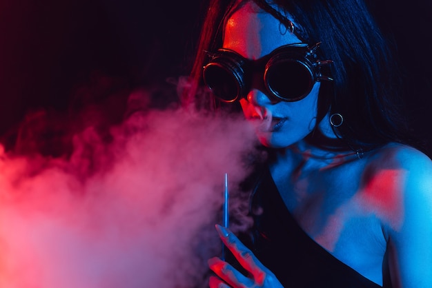 Young woman enjoys smoking a hookah