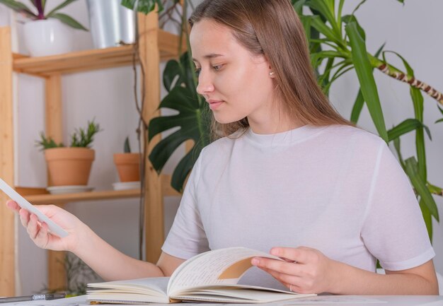 A young woman of european appearance does homework at school,
university. the girl diligently studie