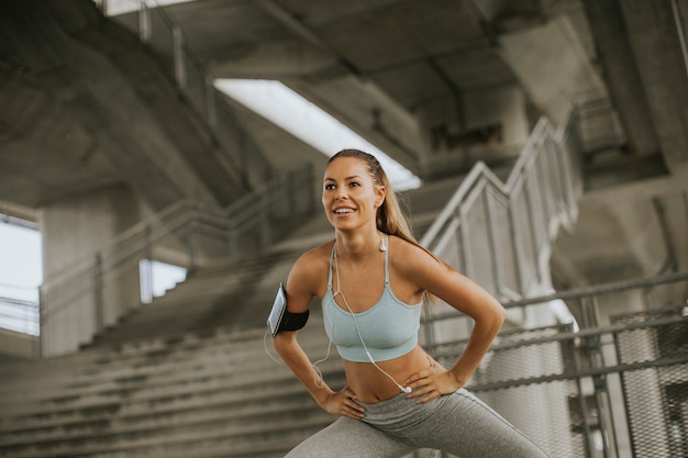 Young woman exercise in urban enviroment by day