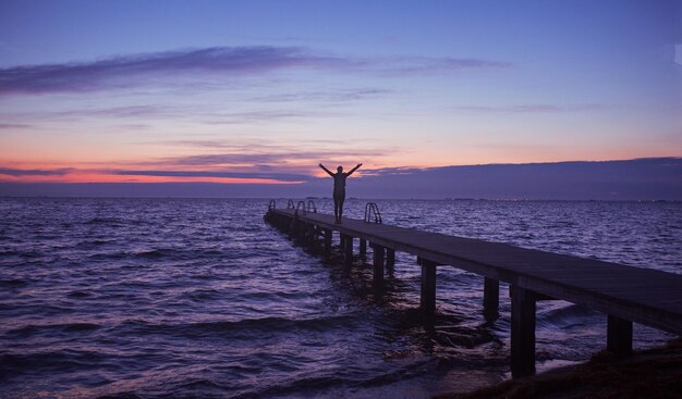 Young woman exercising yoga at sunrise in the morning outdoorsembrace the nature