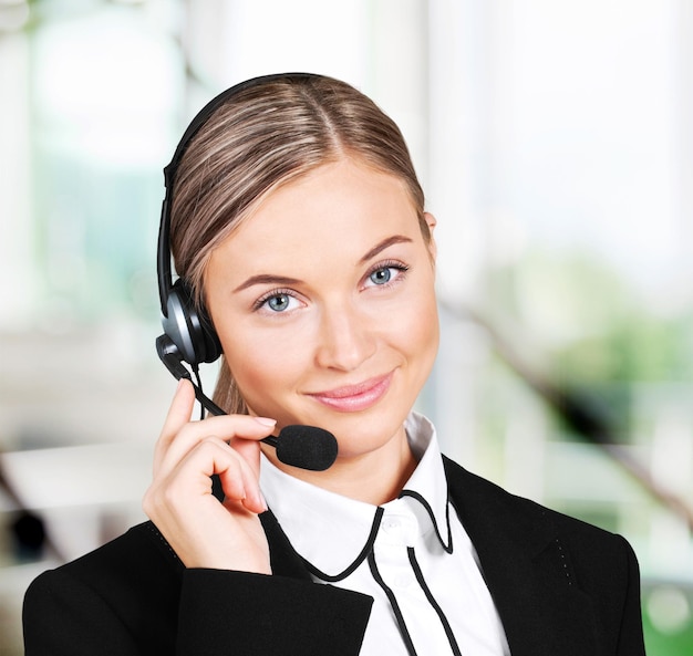 Young woman face with headphones  on background