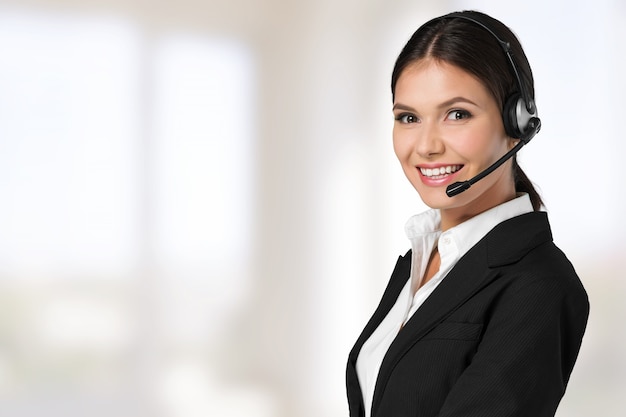 Young woman face with headphones, call center or support concept