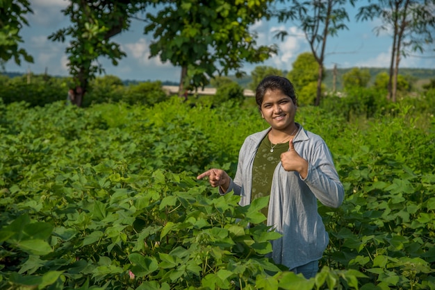 A young woman farmer in a cotton farm field.