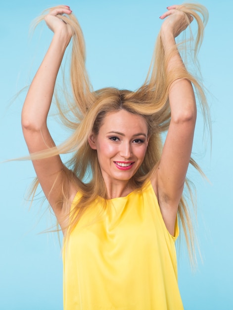 Young woman fashion  portrait on blue wall.