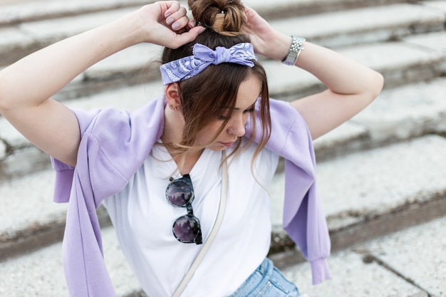 Young woman in fashionable purple spring clothes on the street