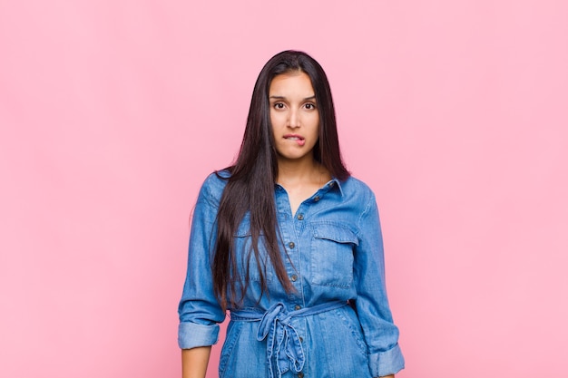 Young woman feeling clueless, confused and uncertain about which option to pick, trying to solve the problem