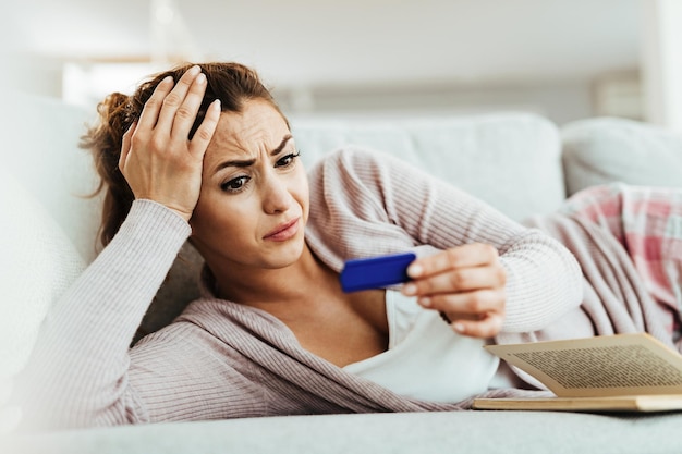 Young woman feeling displeased about her for pregnancy test outcome