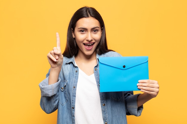 Young woman feeling like a happy and excited genius after realizing an idea