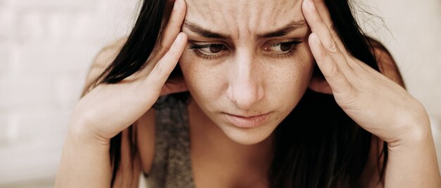 Young woman feeling sick indoors