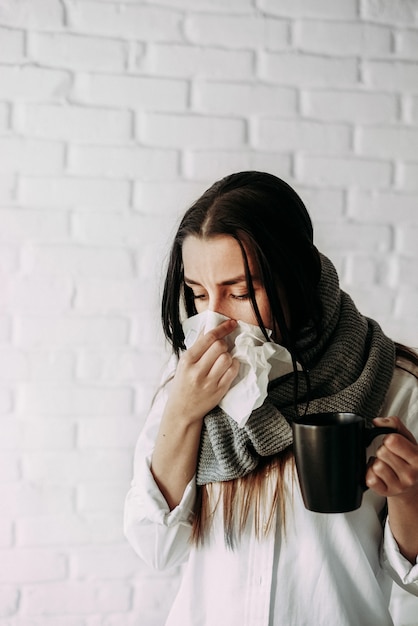 Young woman feeling sick indoors