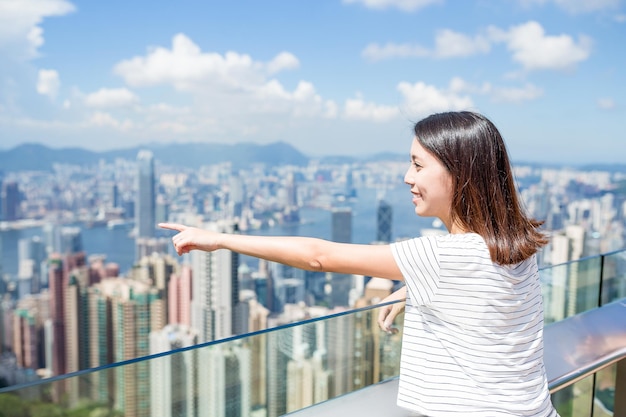 Young woman finger pointint to the location in Hong Kong