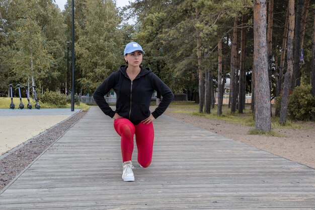 Young woman fitness class in park