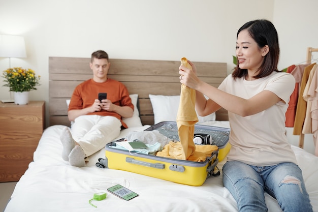 Young Woman Folding Clothes