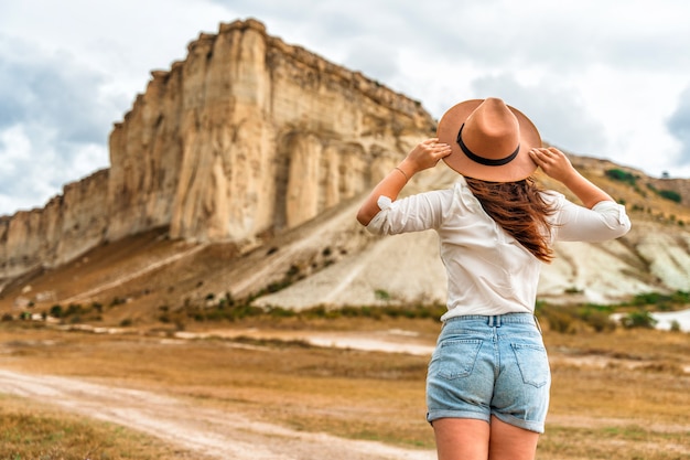 A young woman at the foot of the White Rock in the Crimea Beautiful travel concept