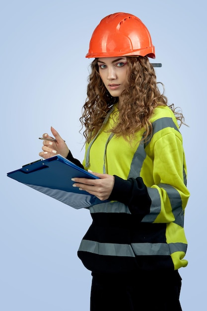 A young woman foreman with a folder in her hands