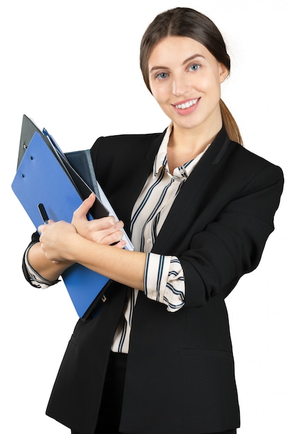 Young woman in formal outfit holding a stack of documents isolated on white background