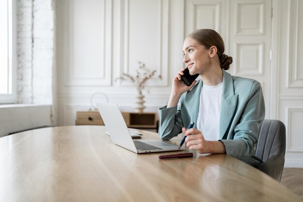 A young woman freelancer manager works in an office uses a computer report in a company