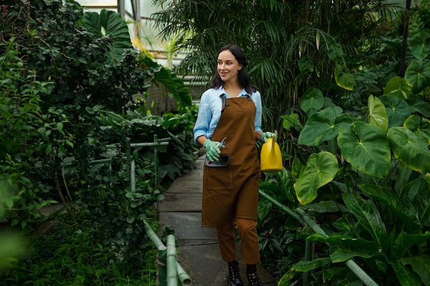 Young woman gardener working in botanic garden