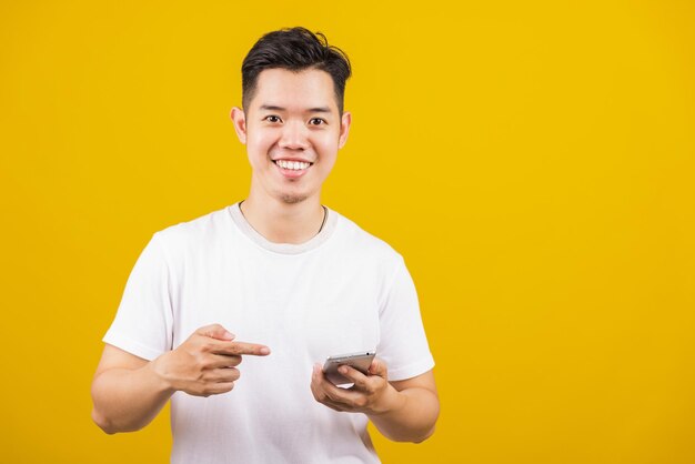 Young woman gesturing against yellow background