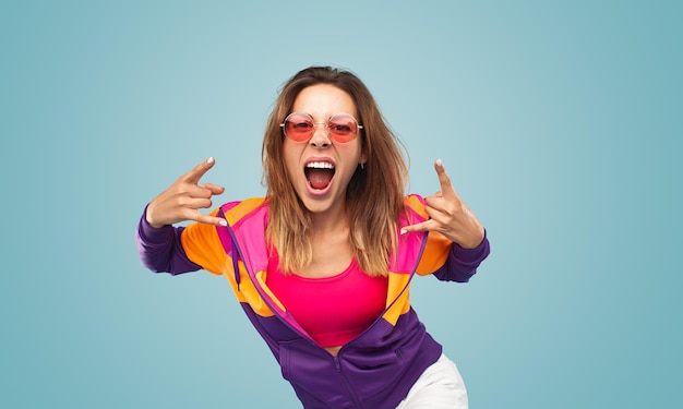 Young woman gesturing rock sign