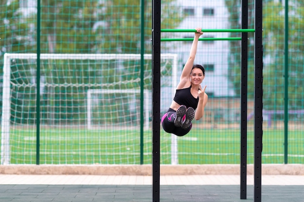 Young woman gesturing and smiling during a workout