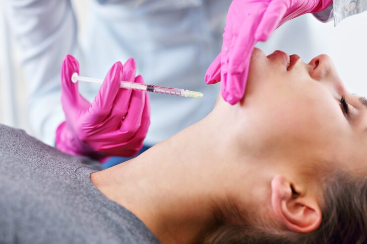 young woman gets cosmetic face injection in beauty salon