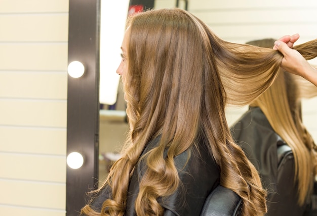 Young woman gets her hair done in a beauty salon