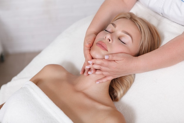 Young woman getting a face massage