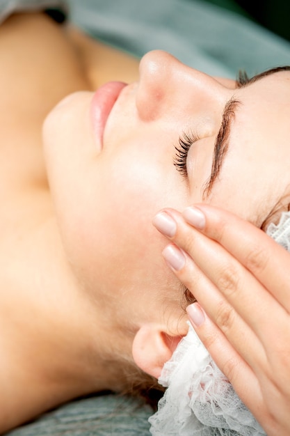 Young woman getting facial massage