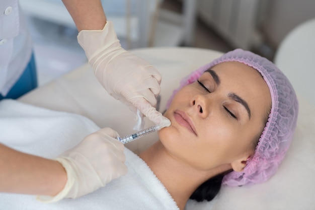 Young woman getting a facial procedure in a clinic