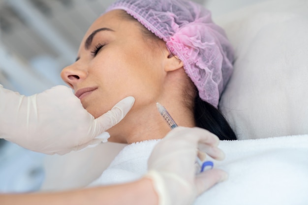 Young woman getting a facial procedure in a clinic