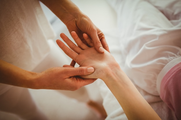 Young woman getting hand massage