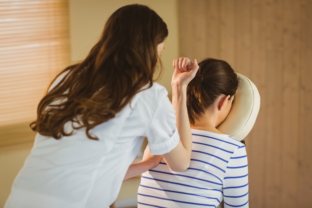 Young woman getting massage in chair