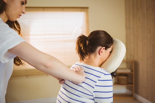 Young woman getting massage in chair