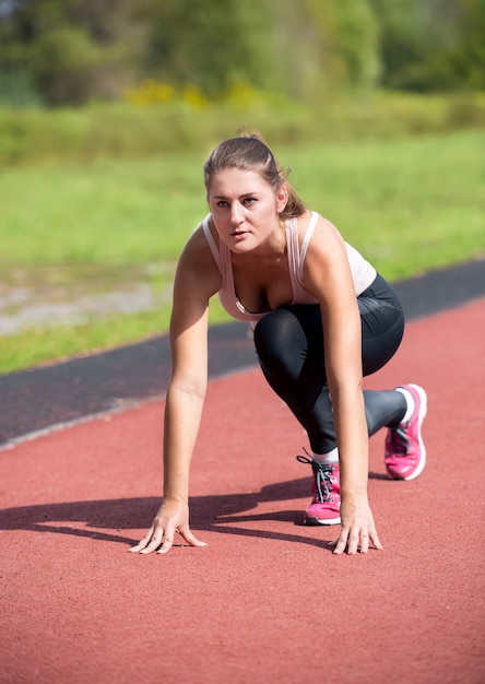 Young woman getting read on the start line for running