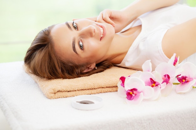 Young woman getting spa massage treatment at beauty spa salon