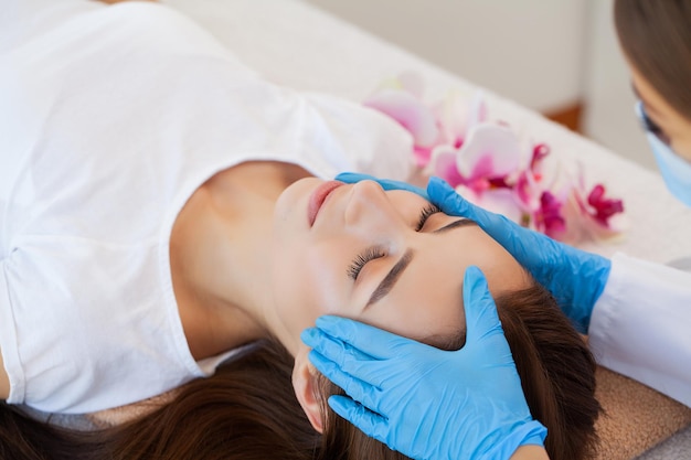 Young woman getting spa massage treatment at beauty spa salon