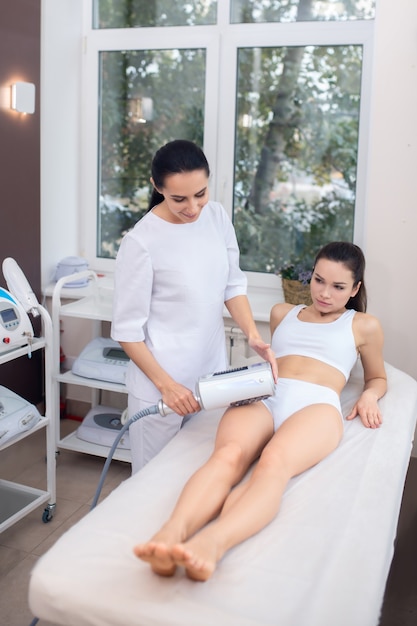 Young woman getting an ultrasound massage therapy